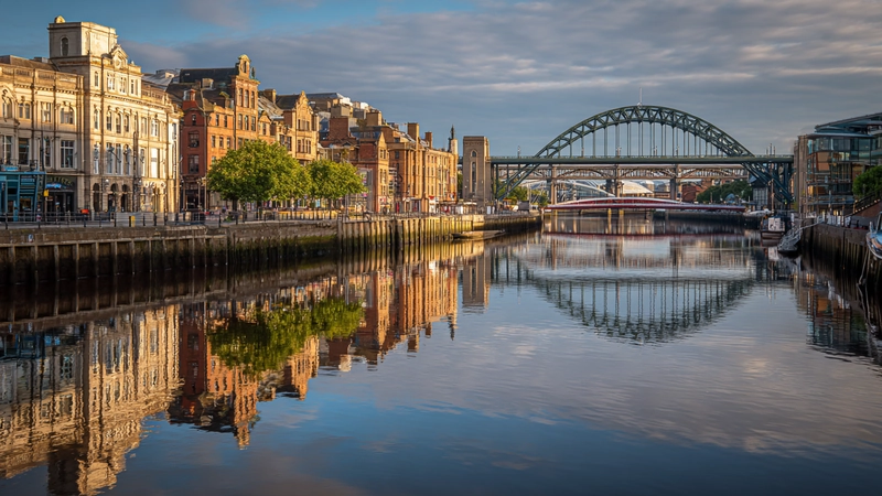 Newcastle quayside with bridge and warm evening light reflecting on water